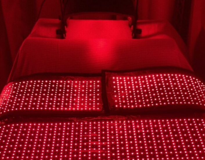 An image of our red light bed shows how red light therapy works